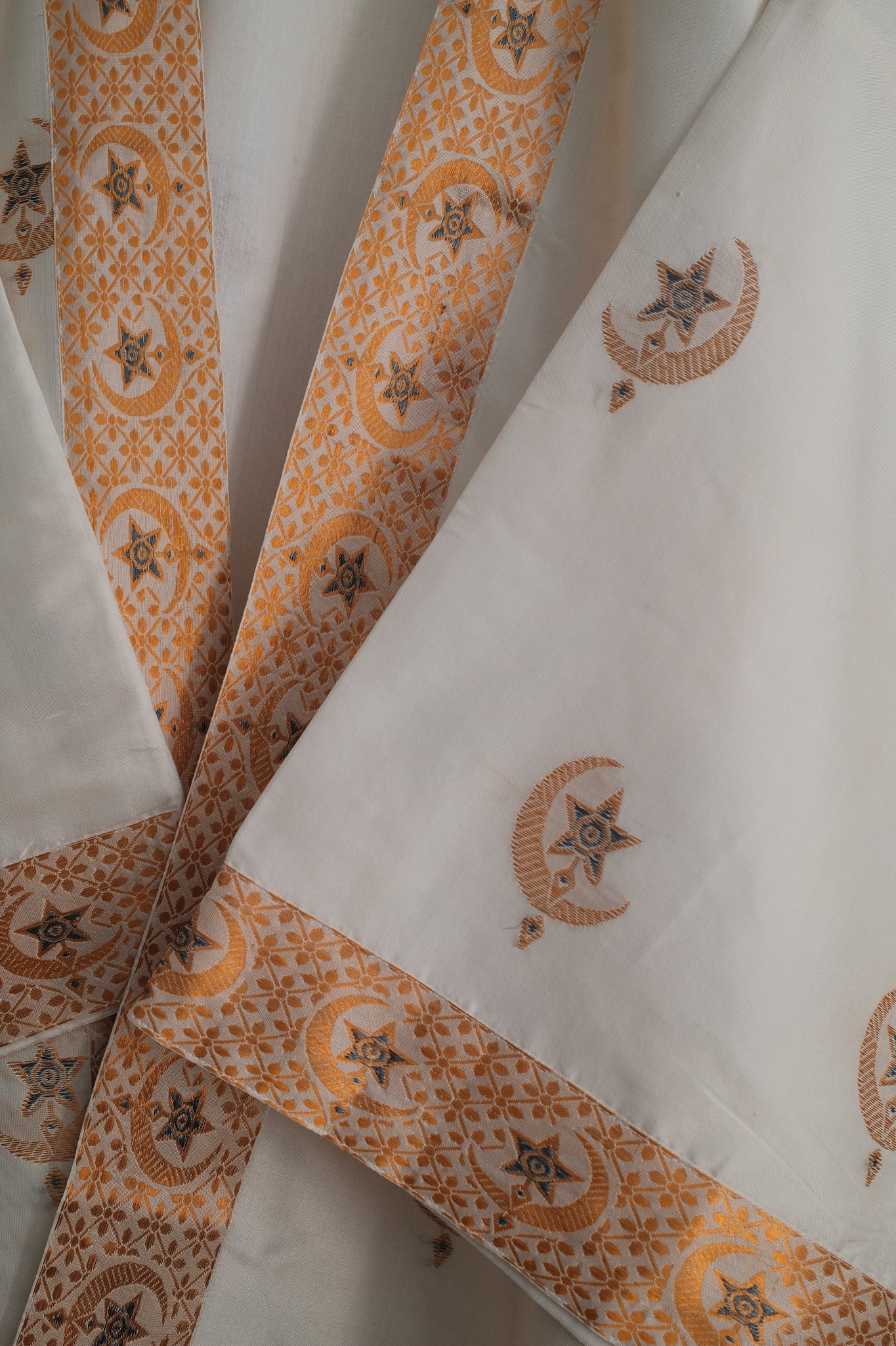 White silk textile with moon and star motif